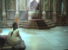 Woman praying in the Church of the Anastasis.
